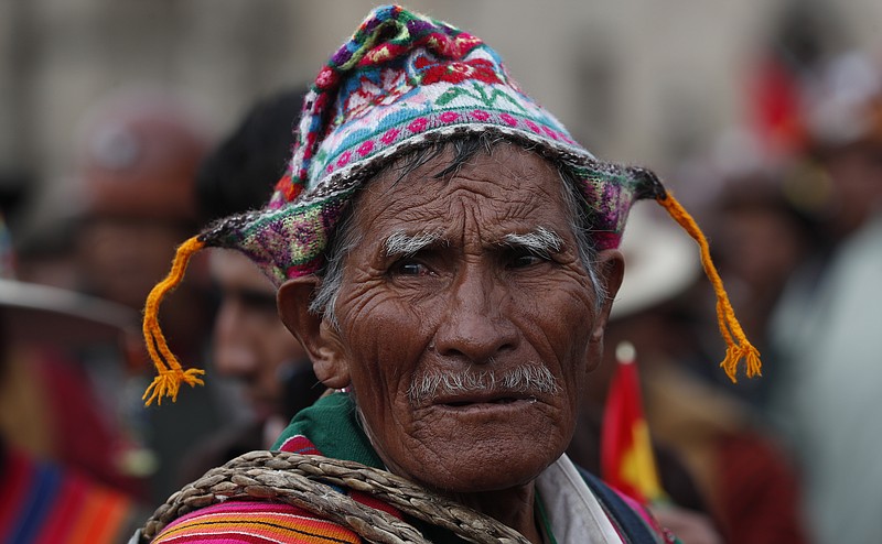 A Quechua indigenous supporter of Bolivian President Evo Morales attends a march in defense of his apparent reelection in La Paz, Bolivia, Tuesday, Nov. 5, 2019. Backers of Bolivia's president blocked the arrival of an opposition leader Luis Fernando Camacho to the capital of La Paz on Tuesday and the government flew him back to his home city amid protests over Morales' apparent reelection. (AP Photo/Juan Karita)