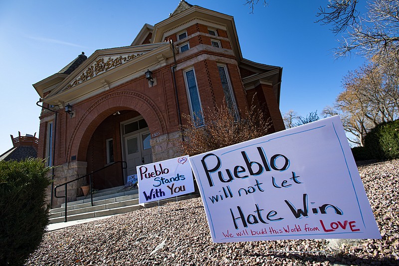Signs, flowers and candles expressing love for the Jewish community stand outside the Temple Emanuel in Pueblo, Colo., Tuesday, Nov. 5, 2019. Richard Holzer, 27, of Pueblo was arrested Friday by the FBI after he allegedly said he was going to go blow up the temple because he hates Jews. Temple president Michael Atlas-Acuña found the items when he arrived in the morning. (Christian Murdock/The Gazette via AP)