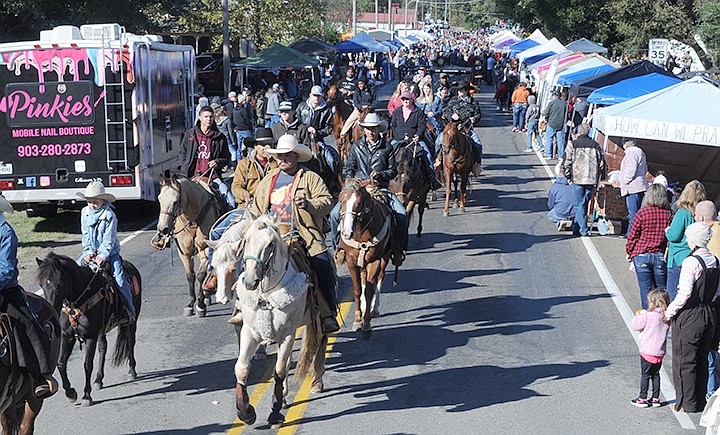 The Cullen Baker Festival in Bloomburg always draws a strong group of horses and riders for its opening parade. In the background are the hundreds who attend the county's most popular one-day event each year.

