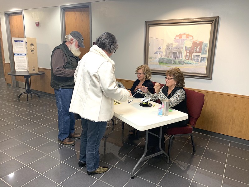 FILE: Fulton resident Susan Johnston receives her election ballot from ballot officials Jackie Pritchett and Diana Hamilton at Fulton City Hall. The Nov. 5 election featured two propositions for tax increases for increased funding for the Callaway County Sheriff's Department as well as money for a new county justice center.