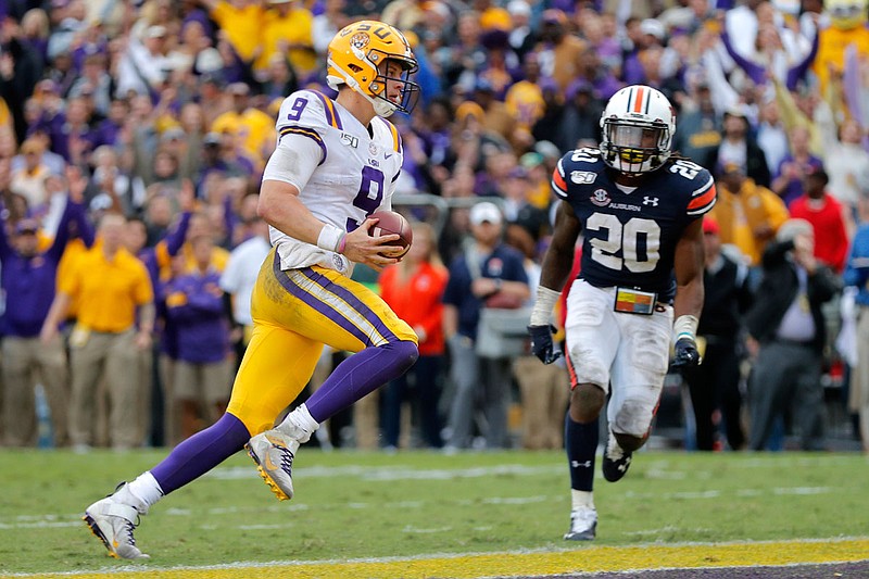 LSU quarterback Joe Burrow runs into the end zone for a touchdown in front of Auburn defensive back Jeremiah Dinson during a game last month in Baton Rouge, La.