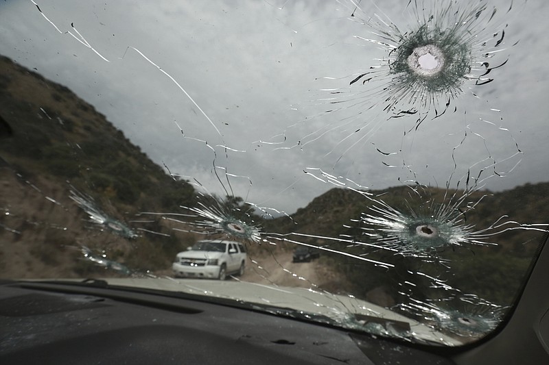 Bullet-riddled vehicles that members of the extended LeBaron family were traveling in sit parked on a dirt road near Bavispe, at the Sonora-Chihuahua state border, Mexico, Wednesday, Nov. 6, 2019. Three women and six of their children, related to the extended LeBaron family, were gunned down in an attack while traveling here Monday. (AP Photo/Christian Chavez)