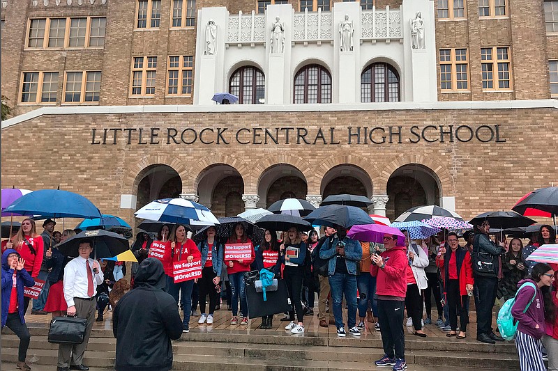 Teachers, students and parents gather outside Little Rock Central High School in Little Rock, Arkansas on Wednesday, November 6, 2019 for a "walk-in." Teachers across the district held similar events to show their opposition to the state no longer recognizing their union and Arkansas' ongoing control of Little Rock schools. (AP Photo/Andrew Demillo)