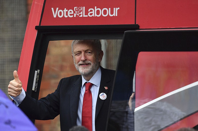 Britain's Labour Party leader Jeremy Corbyn unveils the Labour battle bus while on the general election campaign trail in Liverpool, England, Thursday Nov. 7, 2019. All 650 seats in the House of Commons are up for grabs in the Dec. 12 election, which is coming more than two years early. Some 46 million British voters are eligible to take part in the country's first December election in 96 years. (Jacob King/PA via AP)