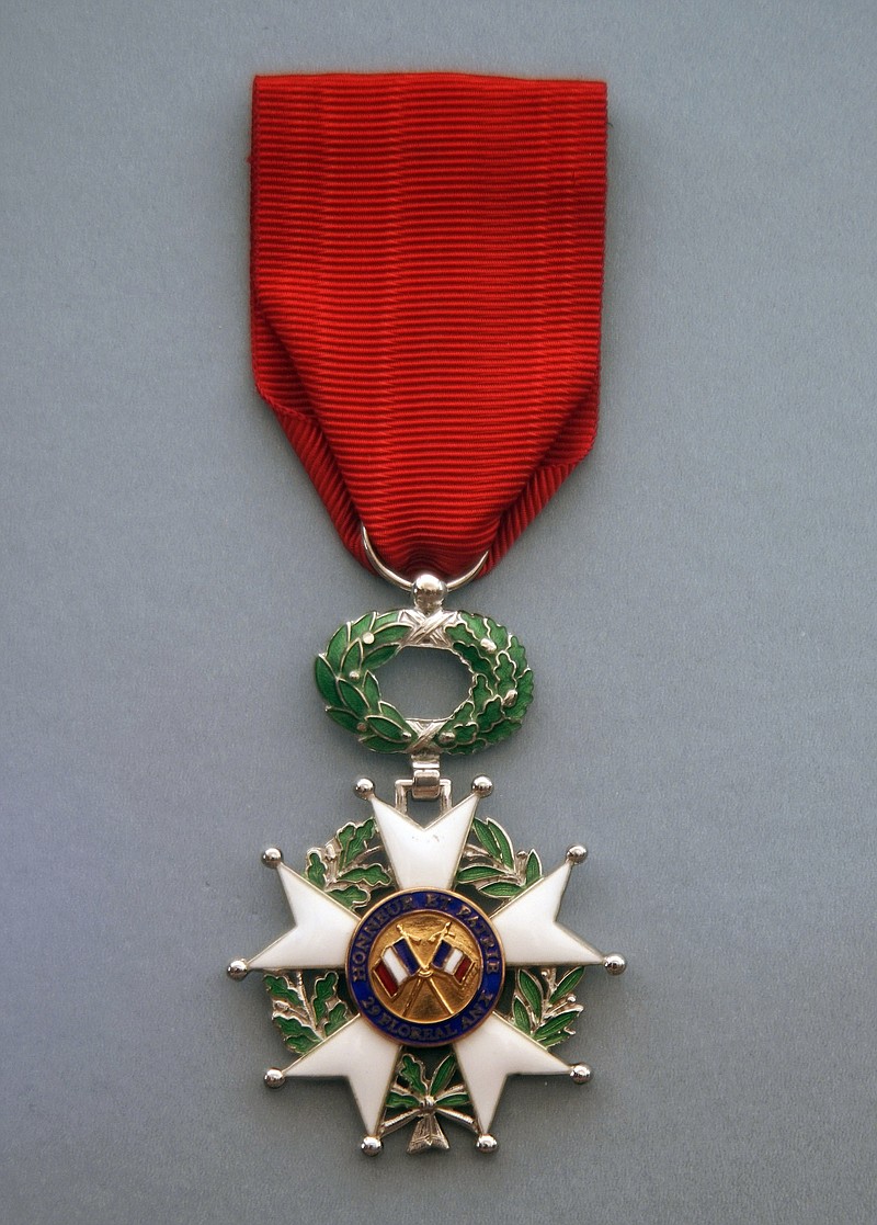 In this Wednesday, Oct. 2, 2019, photo, World War II veteran John Runmancik's French Legion of Honor medal is displayed in Albuquerque, N.M. Rumancik, who flew eight combat missions over Germany, France and Austria, has received the French Legion of Honor medal. Rumancik is the last remaining member of his flight crew. "I wished some of them were still alive so I can share this honor with them," he said. (Adolphe Pierre-Louis/The Albuquerque Journal via AP)