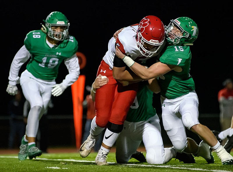 Blair Oaks linebackers Sam Luebbering (15) and Cade Stockman (9) drag St. James running back Gavin Caldwell to the turf in the backfield during the first quarter of last Friday night's Class 3 district game at the Falcon Athletic Complex in Wardsville.