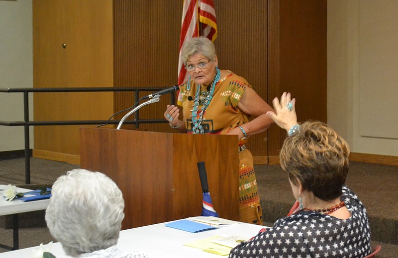 D.J. Carroll, member of the Navajo Nation and fellow clansmember of World War II Code Talker Chester Nez, speaks to the Texarkana, Ark., Daughters of the American Revolution chapter Thursday afternoon at the Texarkana Public Library. Carroll left the Arizona reservation at the age of 16 to further her education through a placement program within the Church of Jesus Christ of Latter-day Saints, which eventually led to her moving to Atlanta, Texas, with her placement family, the Schlossers. (Photo by Kate Stow)

