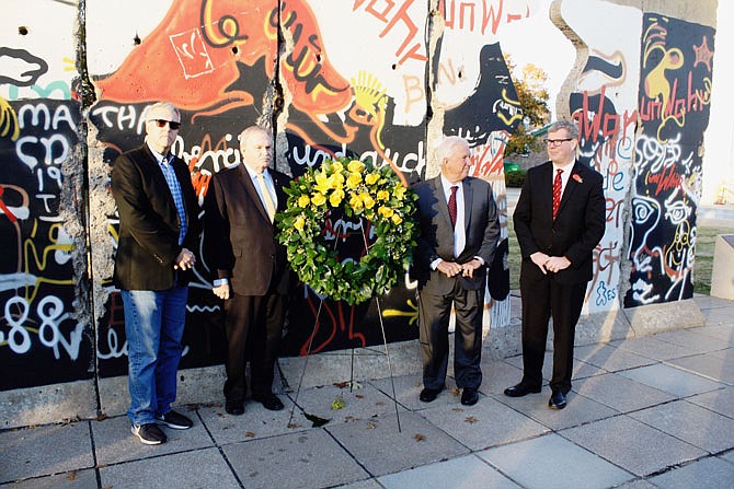 A commemorative wreath was laid Thursday at the remains of the Berlin Wall on Westminster College's campus to honor the 30th anniverary of the wall coming down. Pictured, from left, are Peter Robinson, Ronald Reagan's former speechwriter; Brock Ayers, Westminster Board of Trustees member; Westminster President Fletcher Lamkin; and Tim Riley, the Sandra L. and Monroe E. Trout director and chief curator of the National Churchill Museum.