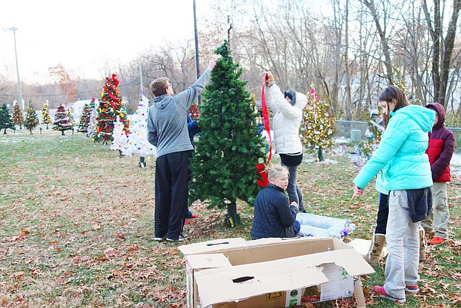 FILE: A group of students and parents from Kingdom Christian Academy decorate a tree in 2018 in the Field of Joy. The field, which benefits Salvation Army, lights up at 5:30 p.m. Dec. 2; sign up by Nov. 15 to participate.