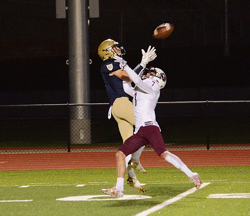 Helias wide receiver Jake Warren jumps over Rolla's Issac Hunter to catch a pass during last Friday night's Class 4 district game at Ray Hentges Stadium.