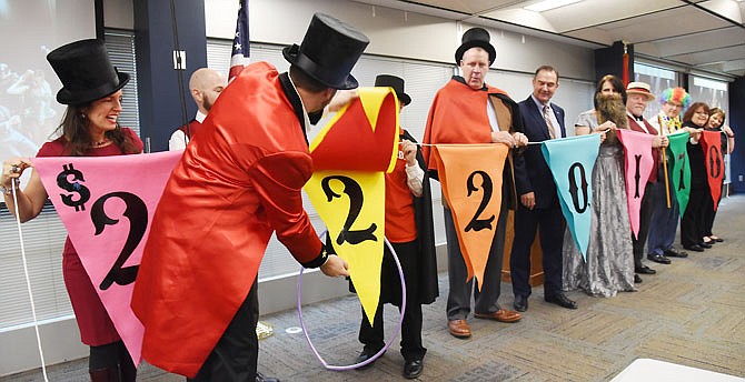 United Way of Central Missouri 2019 campaign co-chair Doug Otto flips the last of the pennants to reveal the projected total of this year's charitable campaign. The unveiling of the $2,220,170 projected to be raised was made during Thursday's victory celebration breakfast at Missouri Farm Bureau Headquarters.