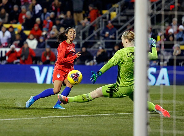United States forward Christen Press (left) scores past Sweden goalkeeper Hedvig Lindahl during the first half of a women's international friendly Thursday in Columbus, Ohio.