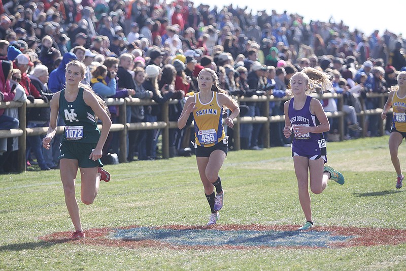 North Callaway junior Kaleigh Moore (left) surges ahead of Fatima senior Alexis Fischer and West County freshman Alivia Simily during the Class 2 girls' state cross country championships Saturday at Gans Creek Recreation Area in Columbia. Moore medalled for the second straight year by finishing 15th in 20:12.2.