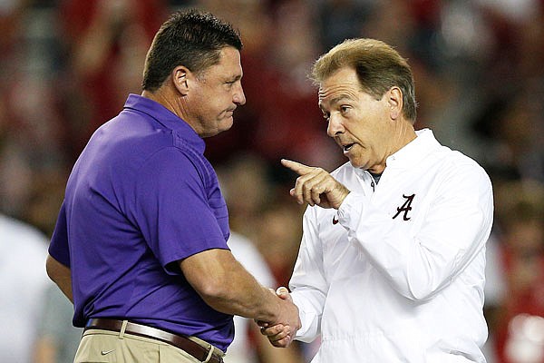 In this Nov. 4, 2017, file photo, LSU head coach Ed Orgeron (left) and Alabama head coach Nick Saban meet at midfield before a game in Tuscaloosa, Ala. For the first time in college football history, this will be the second time teams ranked No. 1 and No. 2 with records of at least 8-0 play, according to ESPN Stats and Info.