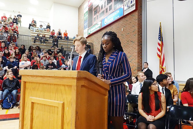 Johnathan Scott and Laurie Shoki read the poem "Lost Generation" at Jefferson City High School. The school held its fifth annual Salute to Service assembly Friday morning.