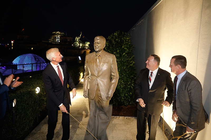 Together with United States Ambassador in Germany Richard Grenell, right, and Fred Ryan Board Chairman of the Reagan Foundation, left, Secretary of State Mike Pompeo unveils a statue of former President Ronald Reagan on the top of United States embassy in Berlin, Germany, Friday, Nov. 7, 2019. AP Photo/Markus Schreiber)