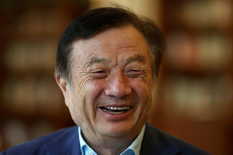 In this Aug. 20, 2019, photo, Huawei's founder Ren Zhengfei reacts as he chats with Huawei executives at the company campus in Shenzhen in Southern China's Guangdong province. Ren says its troubles with President Donald Trump are hardly the biggest crisis he has faced while working his way from rural poverty to the helm of China's first global tech brand. (AP Photo/Ng Han Guan)