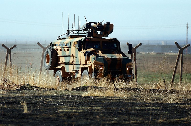 In this photo taken from the outskirts of the village of Alakamis, in Idil province, southeastern Turkey, a Turkish army vehicles is driven in Turkey after conducting a joint patrol with Russian forces in Syria, Friday, Nov. 8, 2019. The Britain-based Syrian Observatory for Human Rights says a protester has been killed when he was run over in the village of Sarmasakh, Syria near the border by a Turkish vehicle during a joint patrol with Russia.The man was among residents who pelted with shoes and stones Turkish and Russian troops who were conducting their third joint patrol in northeastern Syria, under a cease-fire deal brokered by Moscow that forced Kurdish fighters to withdraw from areas bordering Turkey. (AP Photo/Mehmet Guzel)