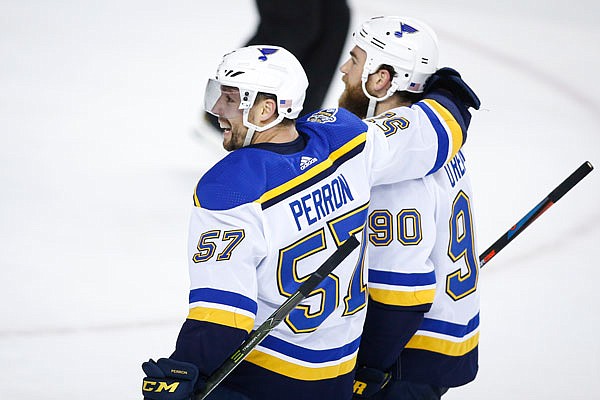 David Perron (left) of the Blues celebrates his game-winning goal with teammate Ryan O'Reilly during overtime of Saturday night's game against the Flames in Calgary.