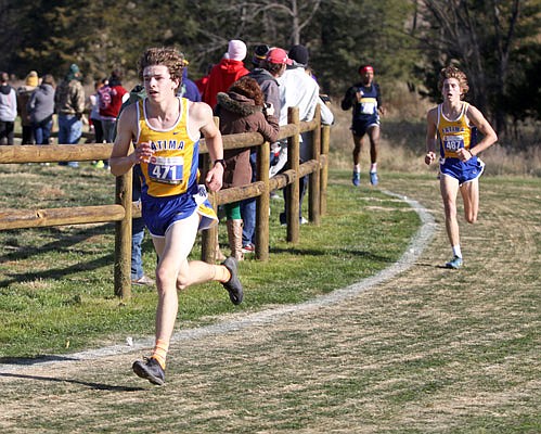 Fatima junior Dawson Woehr (left) races around the last turn before the home stretch as his teammate, junior Lucas Laux, follows during Saturday's Class 2 boys state cross country championships at Gans Creek Cross Country Course in Columbia.