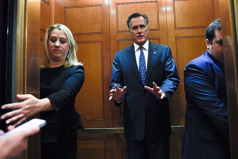 In this Nov. 5, 2019, file photo, Sen. Mitt Romney, R-Utah, gets in an elevator as he is followed by reporters on Capitol Hill in Washington. Republicans have no unified argument in the impeachment inquiry of Donald Trump in large part because they can't agree on how to defend the president.  (AP Photo/Susan Walsh, File)