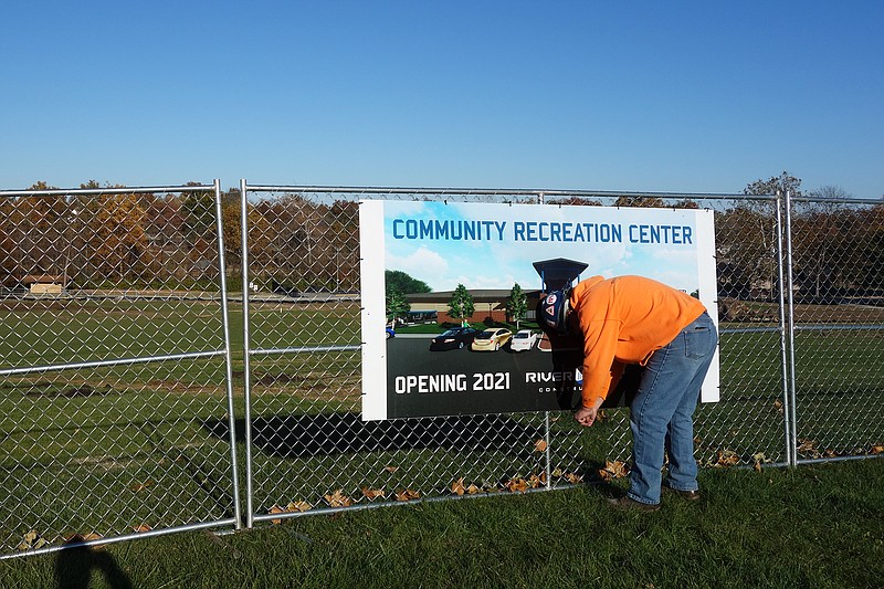 Machines are moving earth at the site of Fulton's future community recreation center. On Friday, Gary Hinners, River City Construction project supervisor, hung the sign announcing the center's projected 2021 opening.