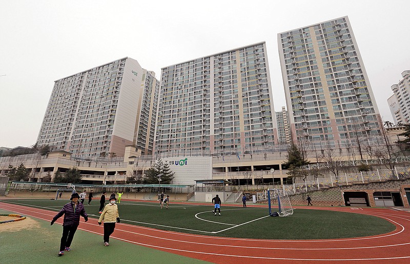 In this Jan. 28, 2016, file photo, residents exercise at a school near an apartment complex, the former location of the Brothers Home, in Busan, South Korea. A notorious South Korean facility that kidnapped, abused and enslaved children and the disabled for a generation was also shipping children overseas for adoption, part of a massive profit-seeking enterprise that thrived by exploiting those trapped within its walls, The Associated Press has found.(AP Photo/Ahn Young-joon, File)