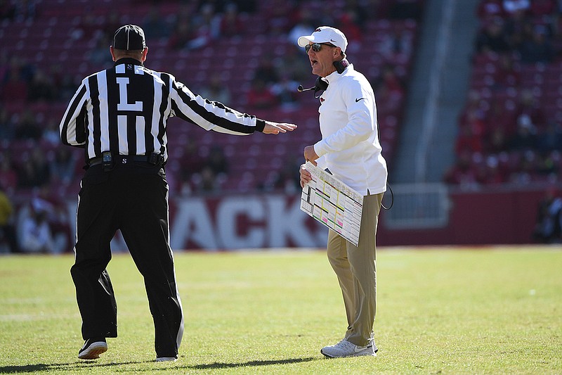Arkansas coach Chad Morris talks with an official Saturday while playing Western Kentucky during the second half of an NCAA football game in Fayetteville, Ark.