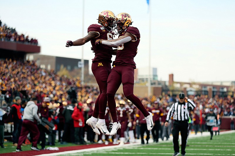 Minnesota wide receiver Rashod Bateman, right, jumps up in celebration with teammate Tyler Johnson after Bateman scored a touchdown against Penn State during an NCAA college football game Saturday, Nov. 9, 2019, in Minneapolis. (AP Photo/Stacy Bengs)