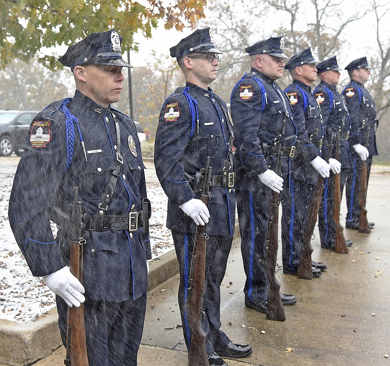 Snow flies around members of the Jefferson City Police Honor Guard as they wait to fire the 21 Gun Salute on Monday, Nov. 11, 2019, during the East Side Business Association's annual Veterans Tribune at McClung Park Pavilion. The event was moved from Freedom Corner due to the day's inclement weather. 