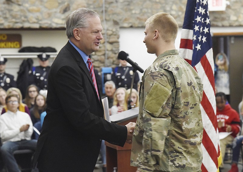 The East Side Business Association's Donnell Rehagen, left, welcomes Curtis Rockers to talk about military future during the ESBA's Veterans Tribute on Monday, Nov. 11, 2019. Rockers is a senior at Helias Catholic High School and a member of the Missouri National Guard.