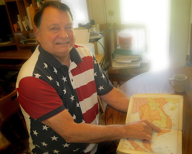 Texarkana, Texas, resident Gene Reynolds studies a map book of Southeast Asia at his home. Reynolds, 77, served in both the Vietnam and Persian Gulf wars. 