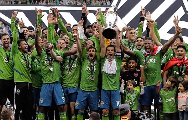 The Seattle Sounders celebrate Sunday after defeating Toronto FC to win the MLS Cup in Seattle.