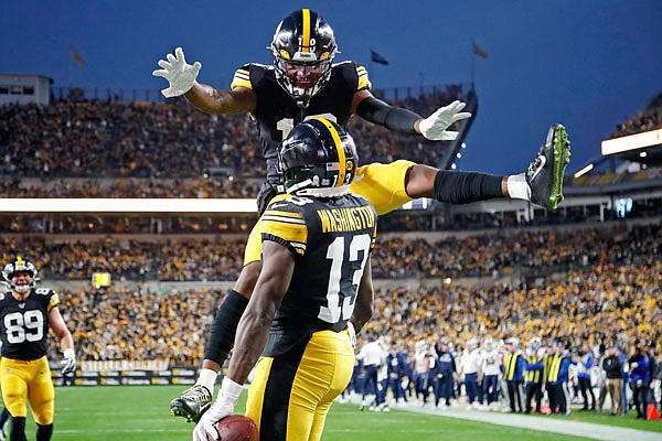 Diontae Johnson of the Steelers leaps to celebrate a touchdown catch by teammate James Washington during Sunday's game against the Rams in Pittsburgh.