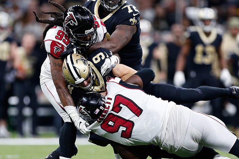 New Orleans Saints quarterback Drew Brees (9) is sacked by Atlanta Falcons defensive tackle Grady Jarrett (97) and defensive tackle Shy Tuttle (99) on Sunday, Nov. 10, 2019, in the second half in New Orleans.