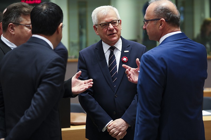 Polish Foreign Minister Jacek Czaputowicz, second right, talks to Lithuanian Foreign Minister Linas Linkevicius, left, Malta's Foreign Minister Carmelo Abela, second left, and Croatian Foreign Minister Gordan Grlic Radman during an European Foreign Affairs Ministers meeting at the Europa building in Brussels, Monday, Nov. 11, 2019. European Union foreign ministers are discussing ways to keep the Iran nuclear deal intact after the Islamic Republic began enrichment work at its Fordo enrichment facility. (AP Photo/Francisco Seco)