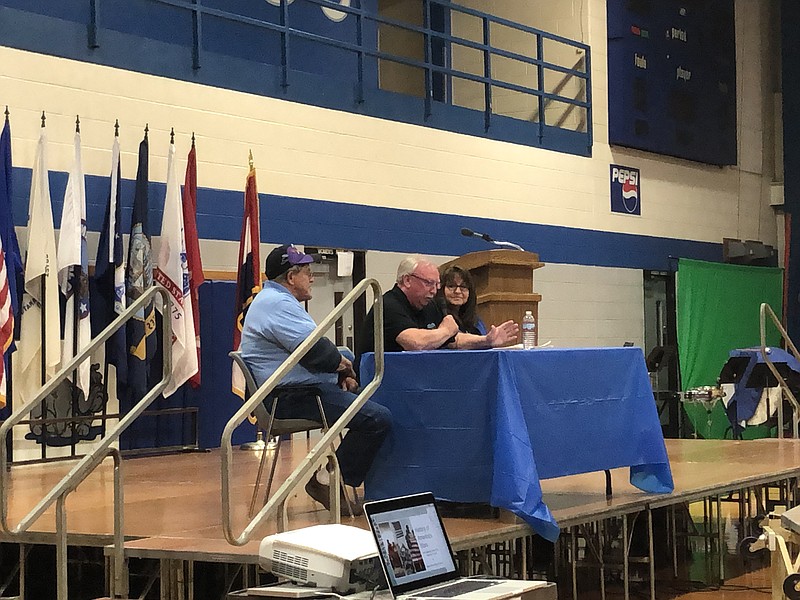 Stan Adams -- a 1966 South Callaway High School graduate, Vietnam War veteran and local author -- speaks to students about what it means to veterans to share their stories and remember the past. Joining Adams on stage were fellow soldier and friend David Hosenfelt, left, and Adams' wife, Rita. (Submitted photo)