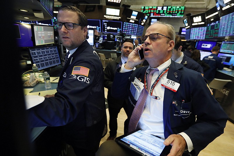 FILE - In this Nov. 7, 2019, file photo specialist Gregg Maloney, left, and trader David O'Day work on the floor of the New York Stock Exchange. The U.S. stock market opens at 9:30 a.m. EST on Monday, Nov 11. (AP Photo/Richard Drew, File)