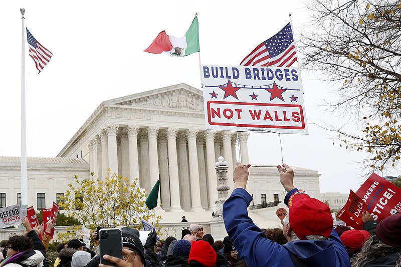 People rally outside the Supreme Court as oral arguments are heard in the case of President Trump's decision to end the Obama-era, Deferred Action for Childhood Arrivals program (DACA), Tuesday, Nov. 12, 2019, at the Supreme Court in Washington. (AP Photo/Jacquelyn Martin)