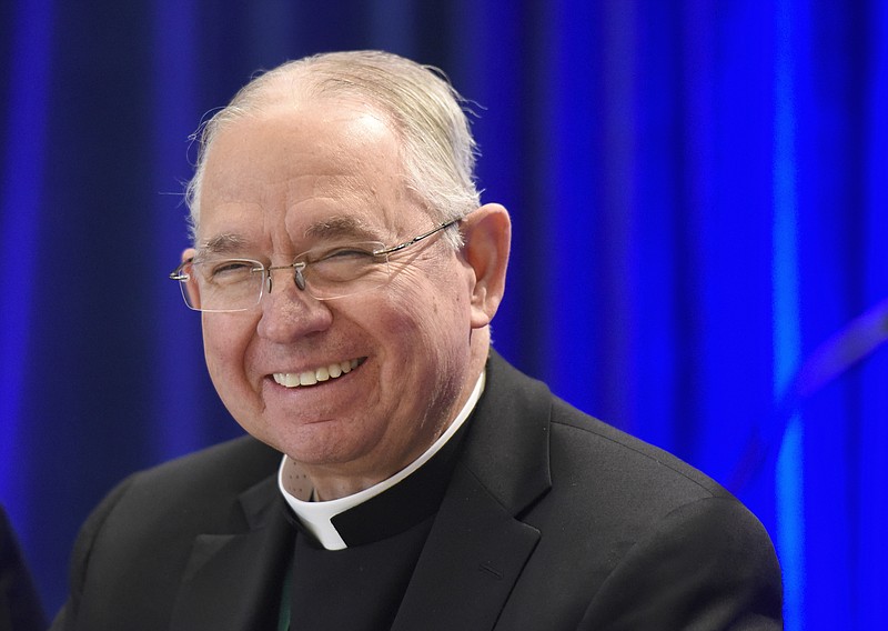 Archbishop Jose H. Gomez, of Los Angeles, smiles during a news conference after being elected president of the United States Conference of Catholic Bishops during their Fall General Assembly on Tuesday, Nov. 12, 2019 in Baltimore. (AP Photo/Steve Ruark)