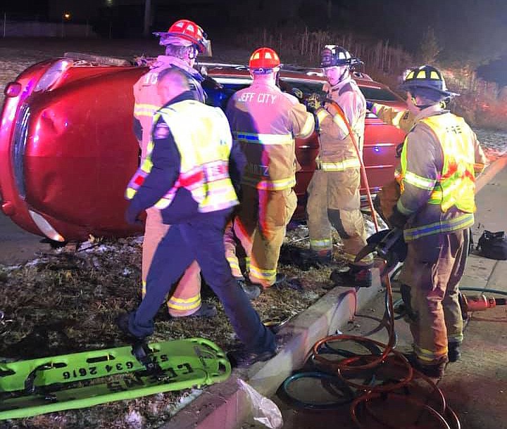 This Jefferson City Fire Department photo shows rescue personnel responding Tuesday night, Nov. 12, 2019, to a car that crashed and rolled over into the front yard of Fire Station 3 at 302 Rock Hill Road. One occupant was able to exit the vehicle while firefighters needed to extricate another.