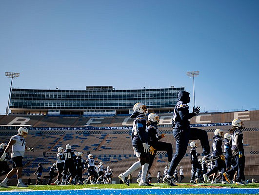The Chargers warm up before the start of their high altitude practice Tuesday at the Falcons Stadium at the United States Air Force Academy in Colorado Springs, Colo.