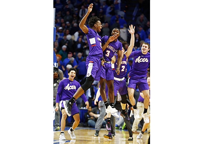 Evansville's DeAndre Williams, top left, and Jawaun Newton (3) celebrate after the team's NCAA college basketball game against Kentucky in Lexington, Ky., Tuesday, Nov. 12, 2019. Evansville won 67-64. (AP Photo/James Crisp)