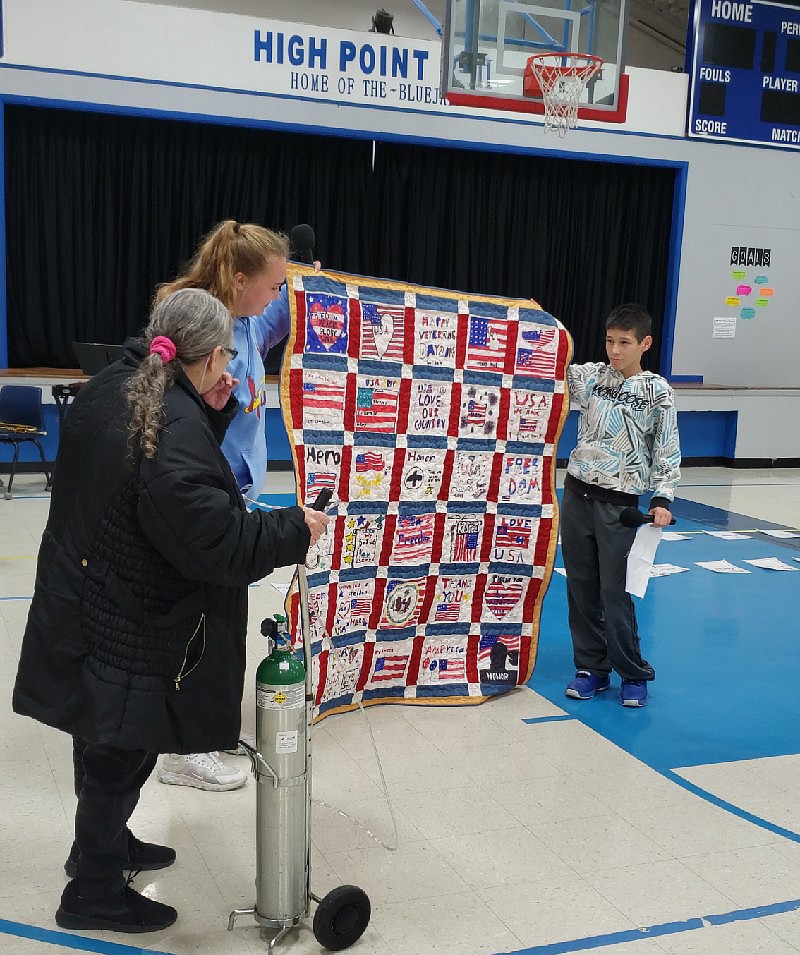 High Point school counselor Dana Bolin crafted quilts using quilt blocks made by High Point's third- through eighth-graders for Friday's Veterans Day breakfast. The two quilts were presented in memory of Dallas Cooper and to active duty Staff Sgt. Amy Wyrick Christensen. (Submitted photo)