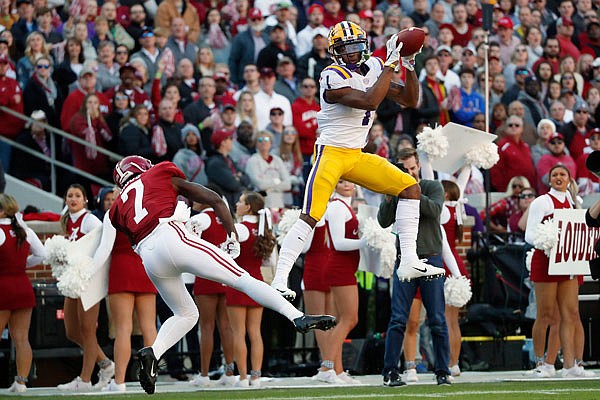 LSU wide receiver Ja'Marr Chase makes a catch for a touchdown as Alabama defensive back Trevon Diggs defends during Saturday's game in Tuscaloosa, Ala.