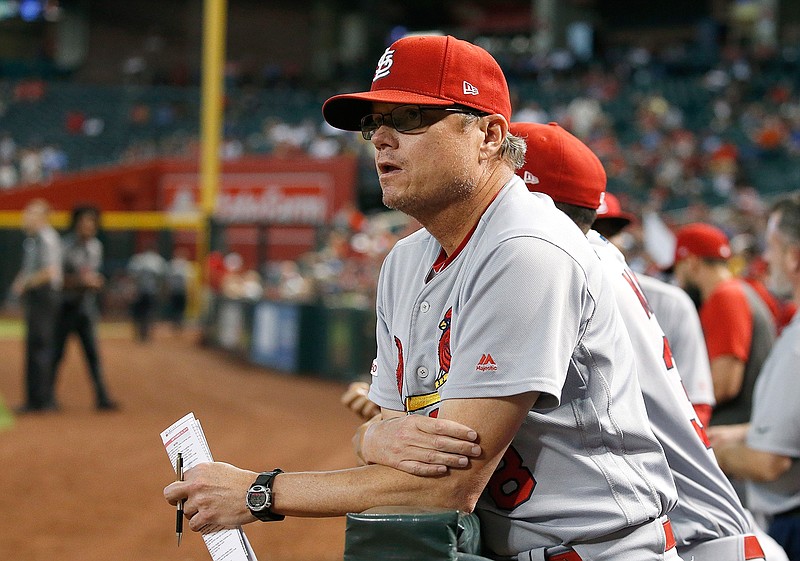 In this Sept. 25, 2019, file photo, St. Louis Cardinals manager Mike Shildt pauses in the dugout during the fifth inning of the team's baseball game against the Arizona Diamondbacks in Phoenix. Shildt has edged out Craig Counsell of the Milwaukee Brewers to win NL Manager of the Year. (AP Photo/Ross D. Franklin, File)