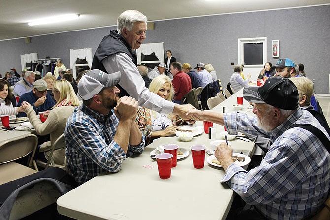 Gov. Mike Parson shakes hands with Moniteau County residents Tuesday as he makes his way around Centennial Hall, the site of the Moniteau County Cattlemen's Association Dinner and Scholarship Night.