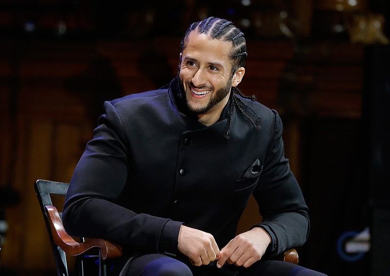 In this Oct. 11, 2018, file photo, former NFL football quarterback Colin Kaepernick smiles on stage during W.E.B. Du Bois Medal ceremonies at Harvard University, in Cambridge, Mass. Kaepernick plans to audition for NFL teams on Saturday, Nov. 16, 2019, in a private workout arranged by the league to be held in Atlanta. (AP Photo/Steven Senne, File)