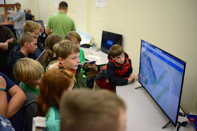 Students from River Oak Christian Academy look at a screen Wednesday showing Surdex mapping during the Geographic Information Systems Open House at the Jefferson City Police Department. The map showed displayed aerial acquisition of affected areas before and after the tornado.