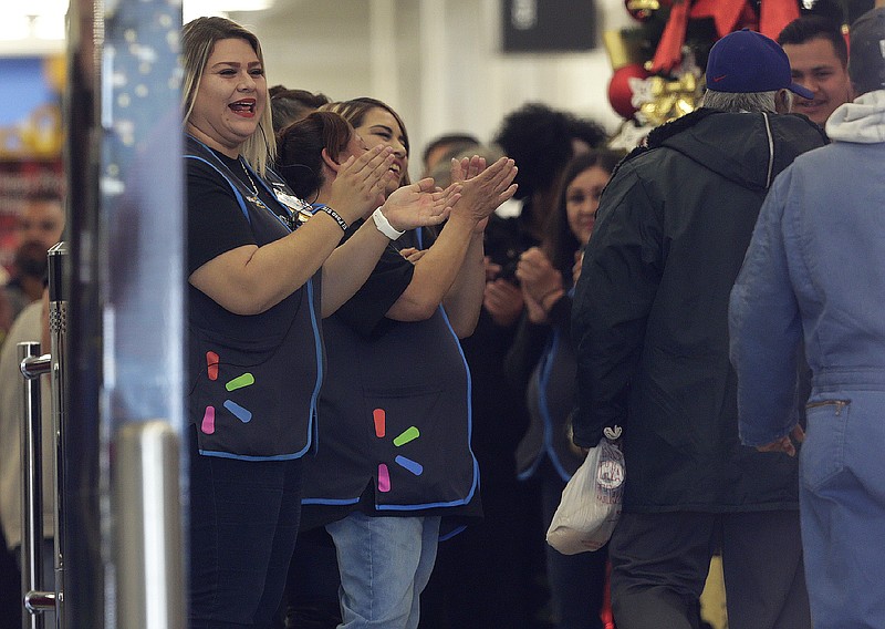 Walmart employees cheer as customers return to the store Thursday, Nov. 14, 2019 in El Paso, Texas.  Customers returned to the store that been closed since August when a gunman opened fire at the store and killed 22 people.  (Mark Lambie/The El Paso Times via AP)